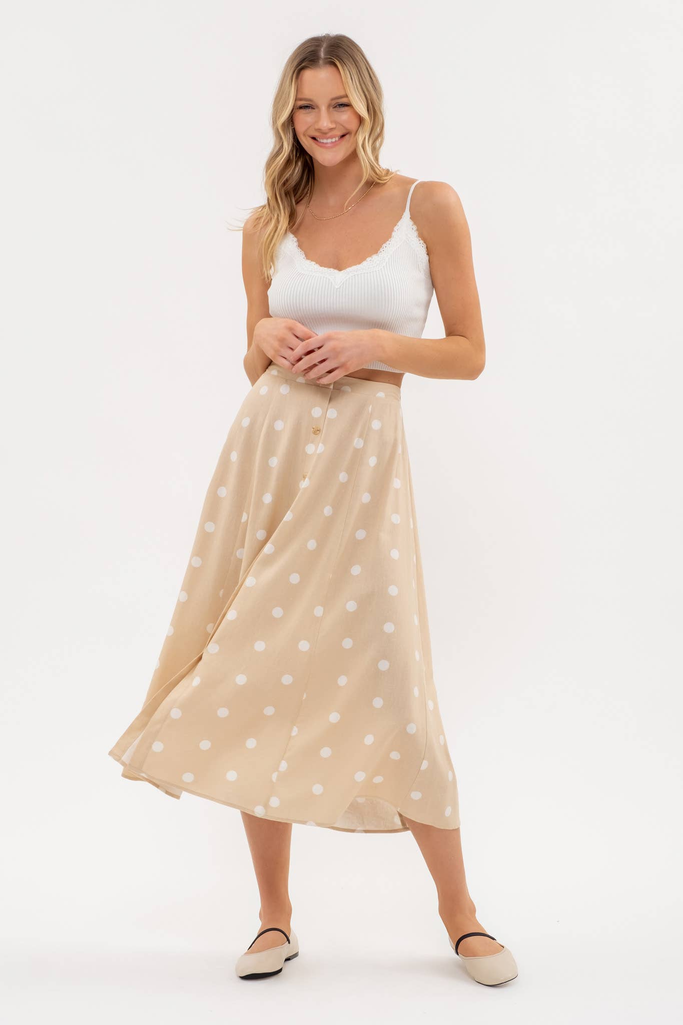 Stylish POLKA DOT BUTTON DOWN MIDI SKIRT with elasticized back and playful polka dot print, perfect for any occasion.