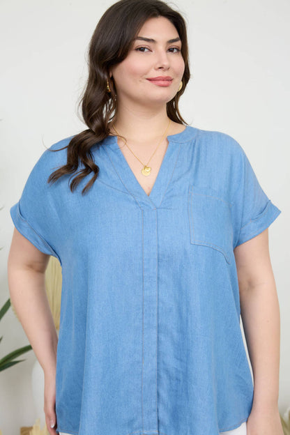 Stylish PLUS BACK BUTTON CUFF SLEEVE CHAMBRAY TOP featuring a split neckline and pocket detail for a trendy look.