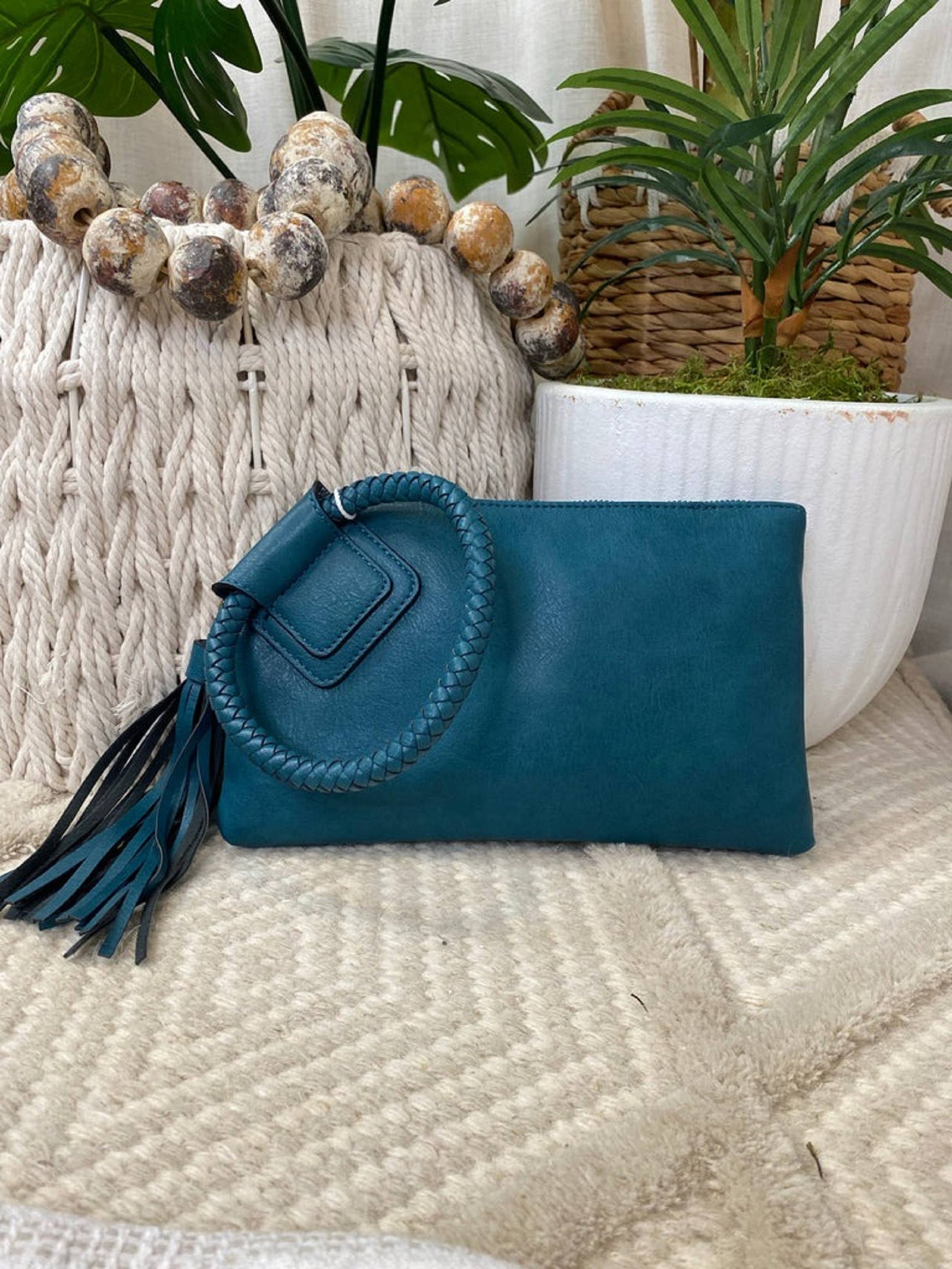 Teal Leather Wristlet/Clutch featuring zip closure and card slots, perfect for adding color to any outfit.