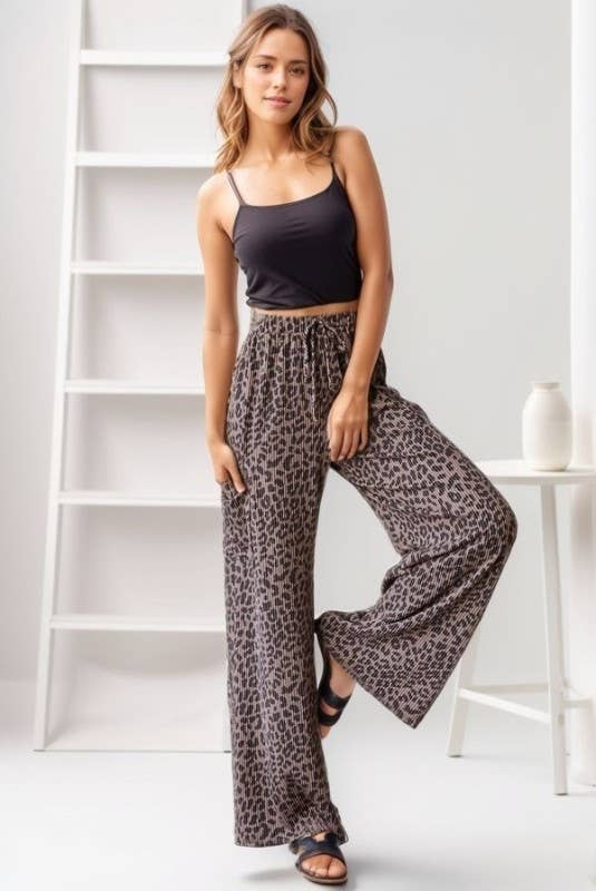 Wild Side Pants: animal-print wide-leg pants with elastic waist, pockets, and drawstring on a model wearing size Small.