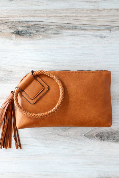 Stylish Leather Wristlet/Clutch with braided handle and tassel, perfect for adding flair to any outfit.