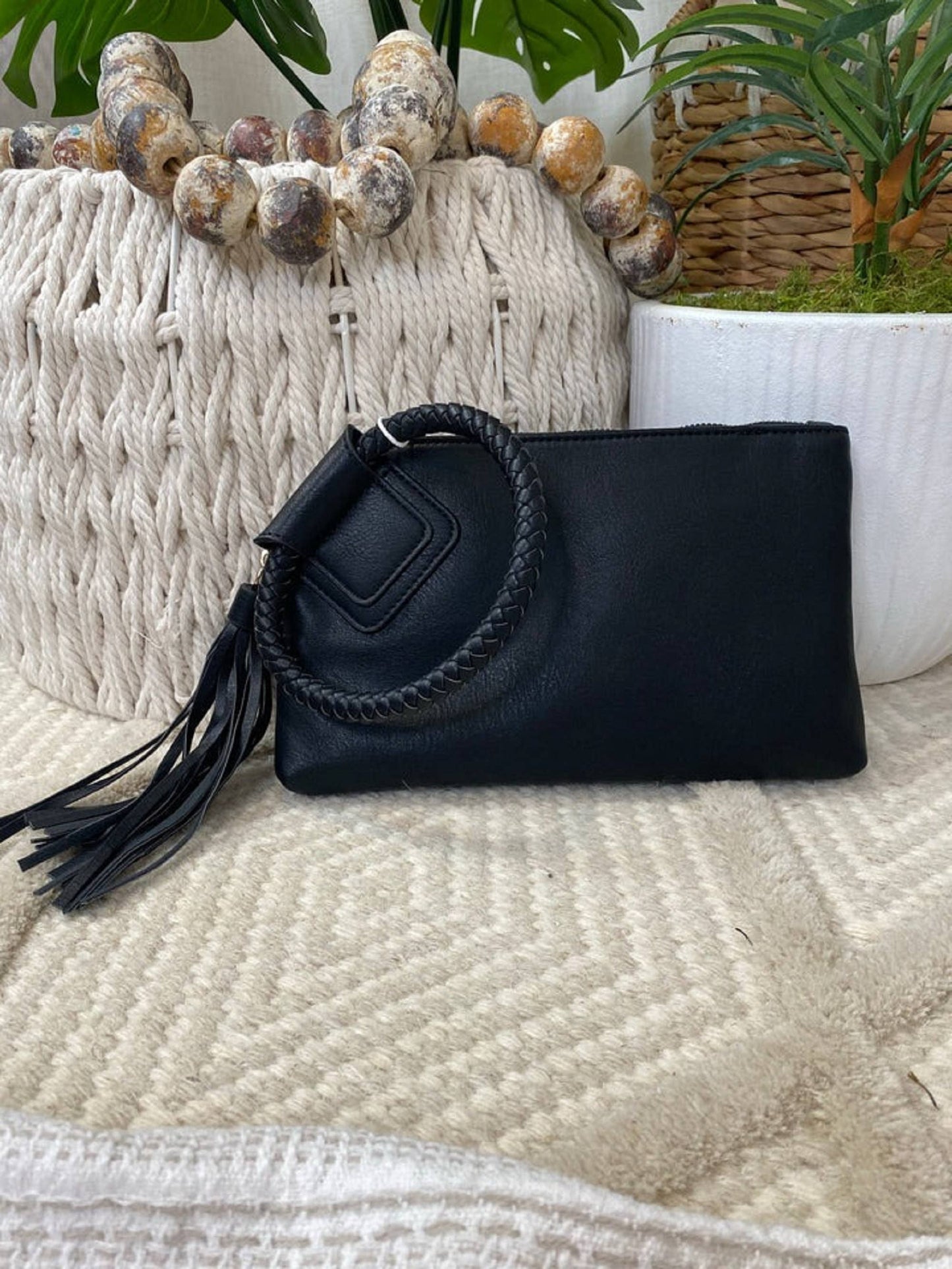 Stylish Leather Wristlet/Clutch featuring zip closure, credit card slots, and a chic braided handle for a fun accessory.