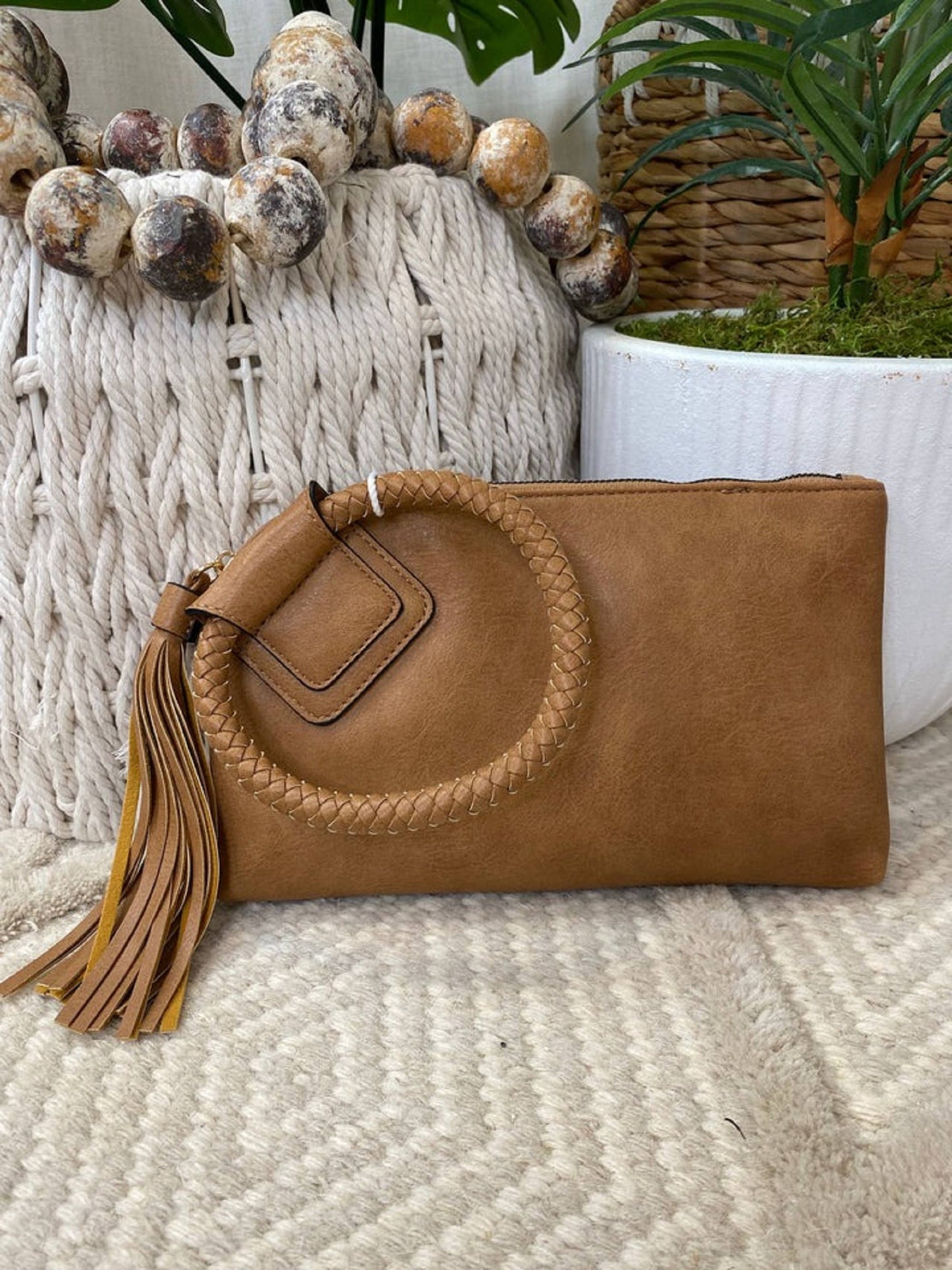 Stylish Leather Wristlet/Clutch with tassel, perfect for adding color to any outfit while keeping essentials organized.
